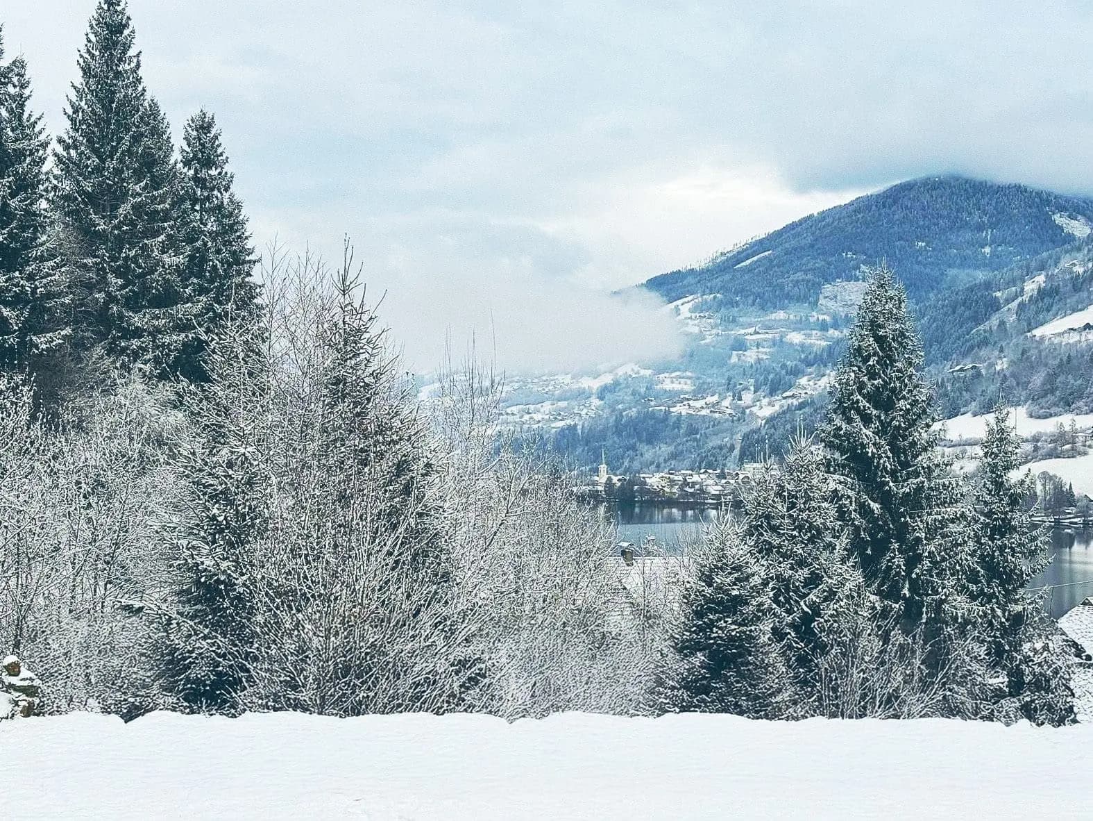 View from Berghaus Seeblick over the snow-covered valley and the Brennsee